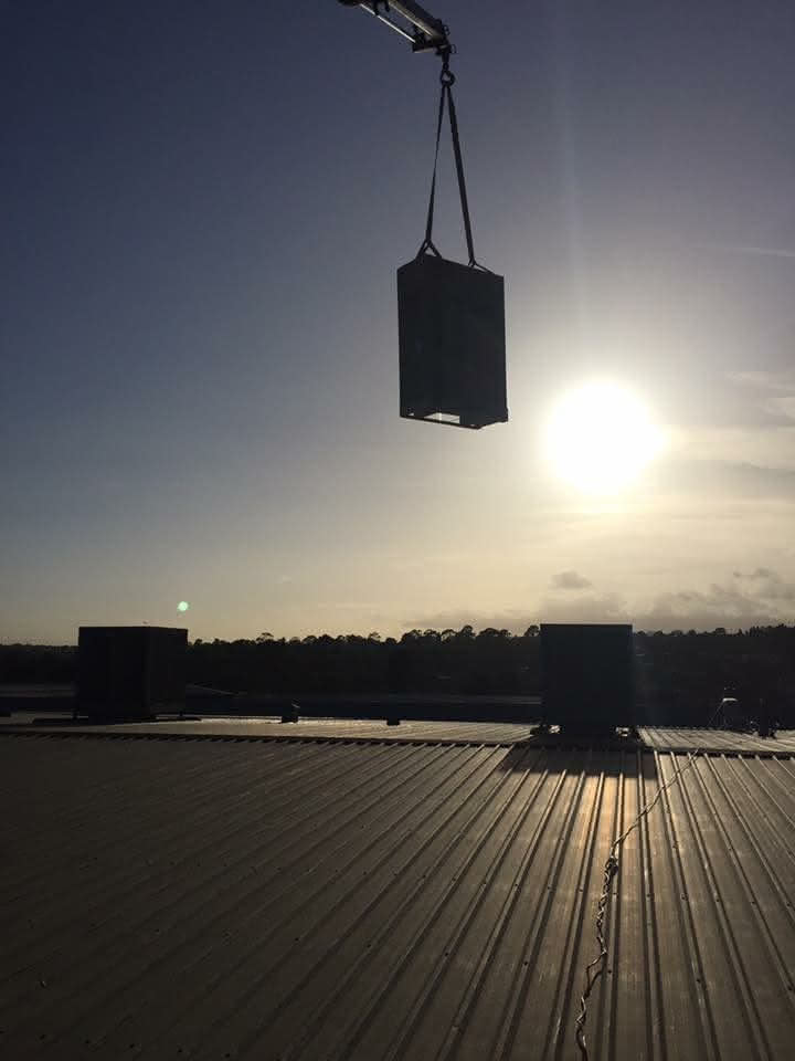 Craning air conditioning system to melbourne rooftop